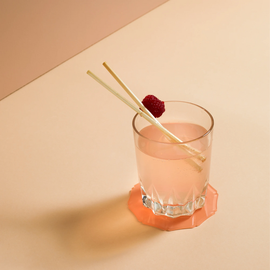 Dit is een foto van een cocktail met 2 natuurlijke tarwerietjes
